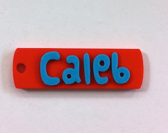 May include: Red plastic keychain with the name "Caleb" printed in blue.