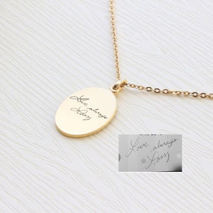 May include: Gold chain necklace with an oval pendant engraved with the handwritten message "Love always, Dad".