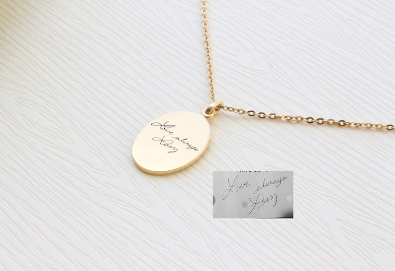 May include: Gold chain necklace with an oval pendant engraved with the handwritten message "Love always, Dad".