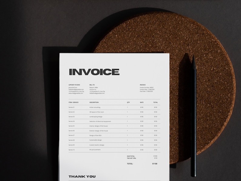 May include: A white invoice with black text, titled "INVOICE," lies on a dark surface. A black pencil rests beside the invoice. The invoice details services, quantities, and rates. A brown, circular coaster is in the background.