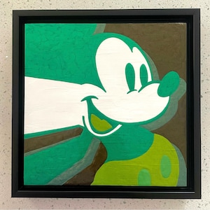May include: A green and white painting of Mickey Mouse's face with a green background. The painting is framed in black.
