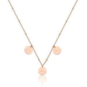 May include: A gold necklace with three round charms, each engraved with a name: Luca, Liam, and Lina.