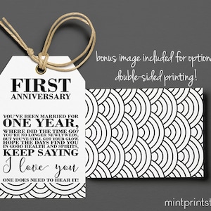 May include: A white gift tag with black text that reads "First Anniversary" and a message about celebrating the first year of marriage. The back of the tag features a black and white geometric pattern.