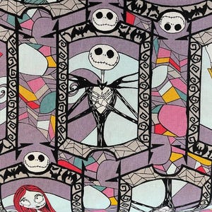 May include: A colorful fabric with a repeating pattern of Jack Skellington from The Nightmare Before Christmas. The pattern features Jack Skellington in a stained glass style with a pink, yellow, and blue background.