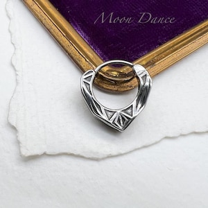 May include: A silver hoop earring with a geometric design. The earring is made of stainless steel and has a polished finish.