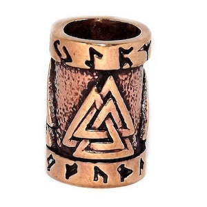 May include: A copper-coloured metal bead with a raised design of a Vegvisir symbol, a Norse directional symbol, surrounded by runes. The bead is approximately 2.5 cm in diameter.