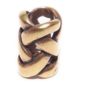 May include: A gold-toned metal braid hair cuff. The cuff is made of a series of interwoven bands that create a braided pattern.