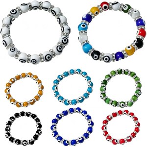 May include: A collection of eight stretch bracelets featuring round beads with evil eye motifs. Each bracelet alternates between eye-patterned beads and small silver-toned spacers embedded with clear crystals, showcasing various colors including white, black, red, blue, green, and yellow.