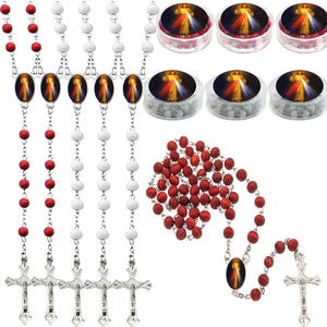 May include: An assortment of rosaries and rosary beads. Several rosaries feature silver crucifixes and oval pendants with a religious image. Some rosaries have red beads, others white. Small, round containers of white beads are also visible.