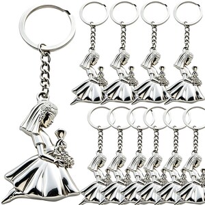 May include: A collection of silver-colored keychains. Each keychain features a detailed figure of a woman in a flowing dress, holding a bouquet. The keychains are connected to a chain and a round key ring.