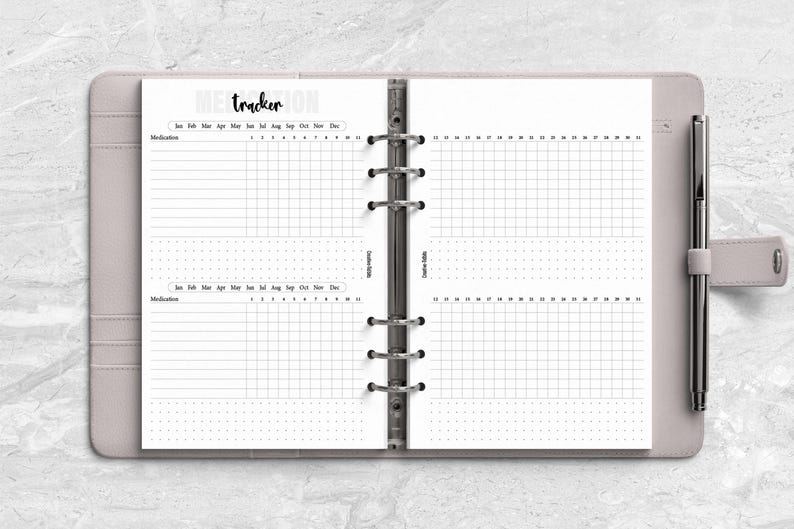 a planner with a pen on top of it