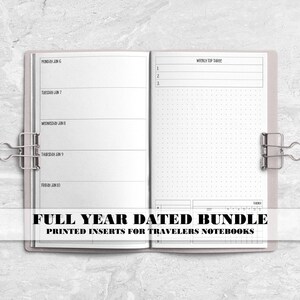 May include: An open planner with white pages featuring black text and lines. The left side shows a weekly schedule with days of the week, while the right side includes a top three tasks list, a dot grid section, and a monthly calendar tracker.