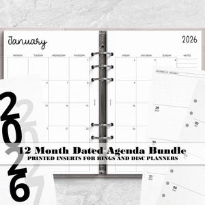 May include: A 12-month dated agenda bundle featuring white paper inserts for ring and disc planners. The pages display a January 2026 monthly calendar layout with black text, a grid structure, and a vertical 2026 year label on the cover sheet.