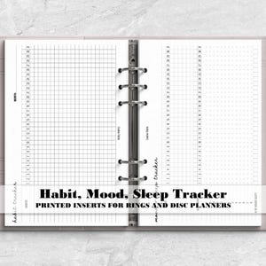 a spiral bound notebook with the words habit, mood, sleep tracker printed on it