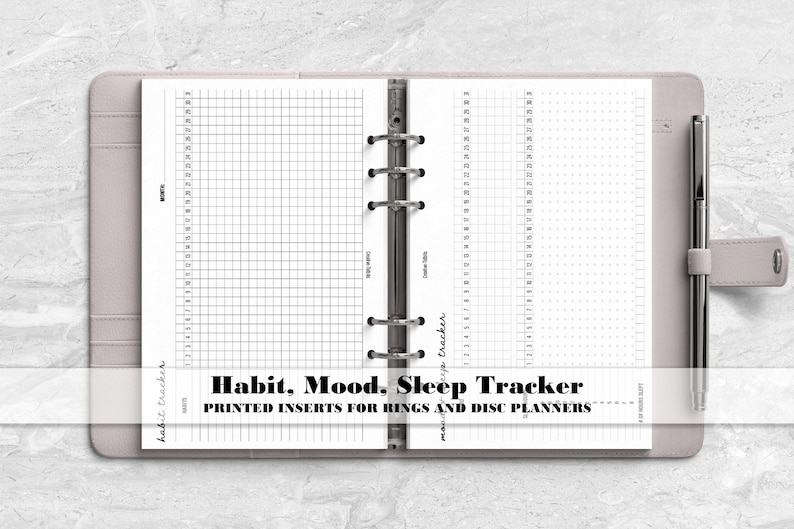 a spiral bound notebook with the words habit, mood, sleep tracker printed on it
