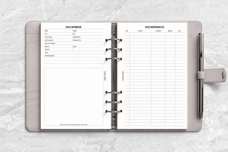 a planner with a pen on top of it