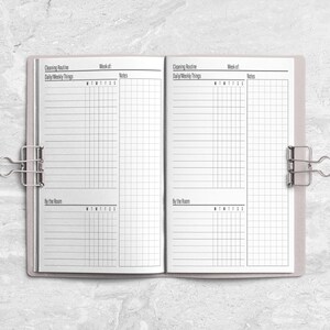 a planner is open on a marble surface