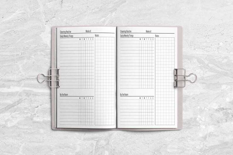 a planner is open on a marble surface