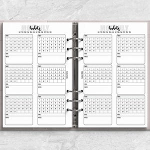 a planner with a pen on top of it