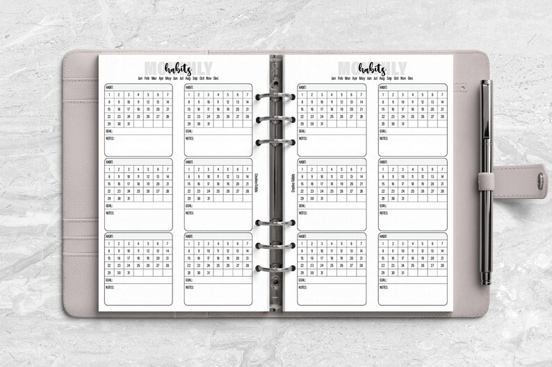 a planner with a pen on top of it