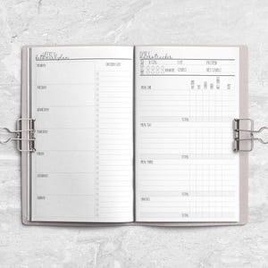 a planner is open on a marble surface