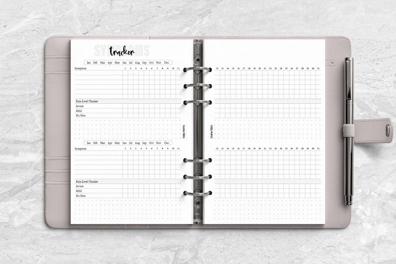 a planner with a pen on top of it