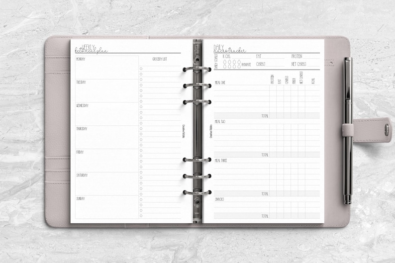 a planner with a pen on top of it