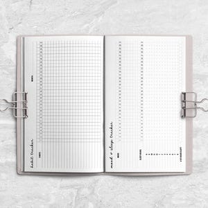 an open notebook on a marble surface