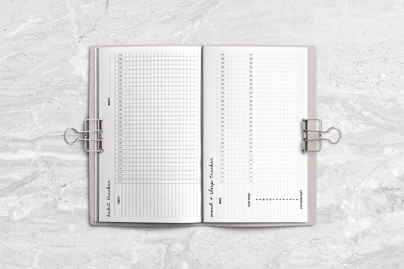 an open notebook on a marble surface