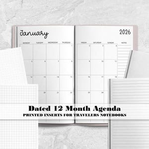 May include: A 2026 dated 12-month agenda with printed inserts for travellers notebooks. The open planner displays a January calendar grid, while surrounding inserts feature dot grid, graph paper, and lined pages with black text on white paper.