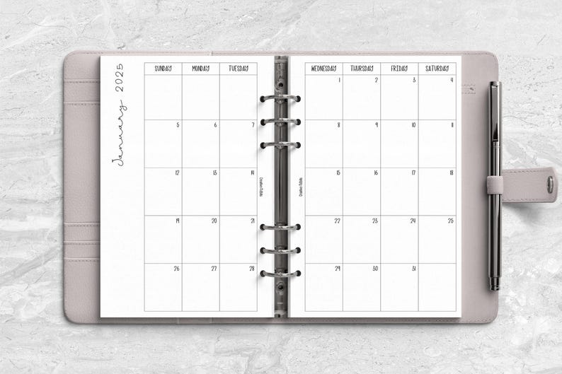 a planner with a pen on top of it