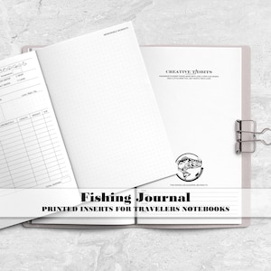 May include: A white paper fishing journal insert for travelers notebooks featuring a dot grid page and a printed log template with fields for date, time, location, weather, species, length, and weight, secured by a silver metal binder clip.