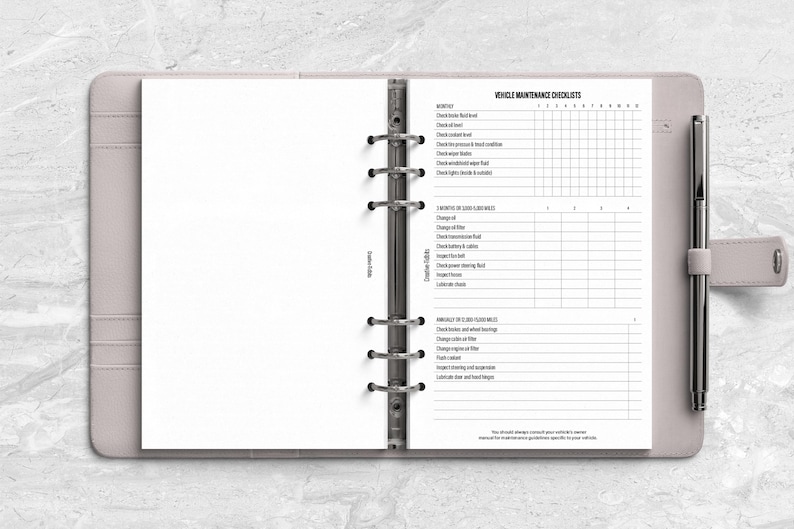 a planner with a pen on top of it