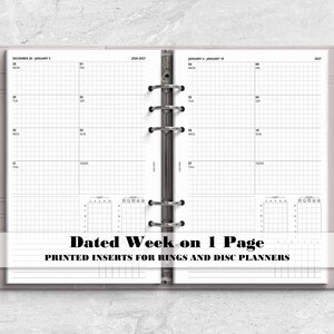May include: A light gray six-ring binder containing white paper inserts with a dated weekly planner layout. The pages feature a grid design, daily columns, and small habit trackers. A silver pen is held in the side loop of the binder cover.