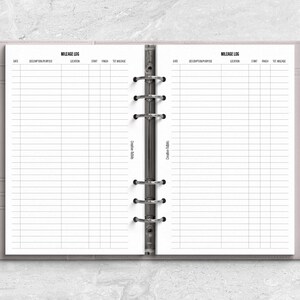 a planner with a pen on top of it