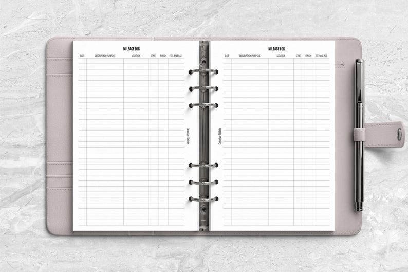 a planner with a pen on top of it