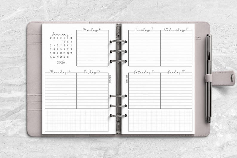a planner with a pen on top of it