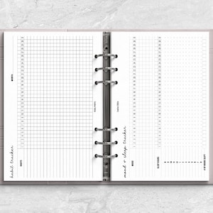 a planner with a pen on top of it