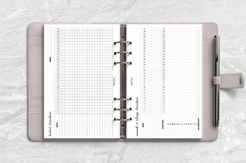 a planner with a pen on top of it