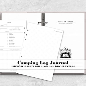 May include: A set of white paper planner inserts for a ring binder, featuring a camping log template with fields for campground details, amenities, and activities, alongside a dot grid page with a mountain and tent graphic and a silver pen.