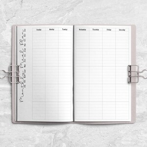 a planner with a pen on top of it
