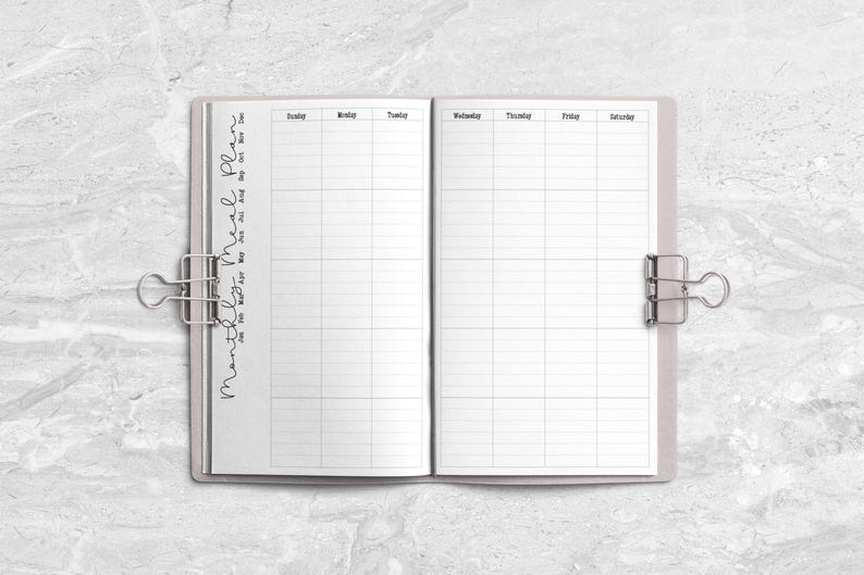 a planner with a pen on top of it