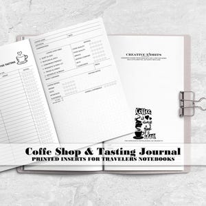 May include: A coffee shop and tasting journal with printed inserts for travelers notebooks. The pages feature black text and graphics, including a coffee cup icon, rating scales, and the phrase Coffee is always a good idea. A metal binder clip holds the pages.