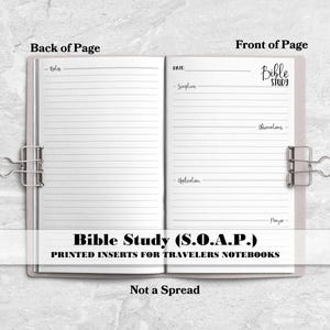 May include: An open notebook with two pages held by silver binder clips. The left page is lined for notes. The right page features printed headers for Bible Study, Scripture, Observations, Application, and Prayer. Text includes Back of Page, Front of Page, Bible Study, and Bible Study (S.O.A.P.) Printed Inserts for Travelers Notebooks, Not a Spread.
