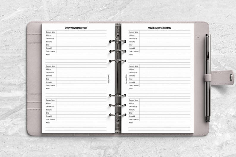 a planner with a pen on top of it
