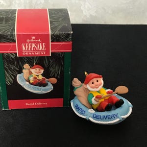 1992 Hallmark Keepsake Ornament &quot;Rapid Delivery&quot; Santa in Raft with Oak & Bag