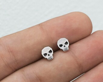 Skull stud silver earrings is a cool piercing for him or for her