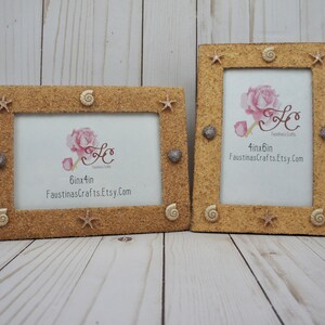 May include: Two sand-textured picture frames with seashell accents. The larger frame is 6 inches by 4 inches and the smaller frame is 4 inches by 6 inches. Both frames have a light brown color and feature seashells, starfish, and a pink rose.