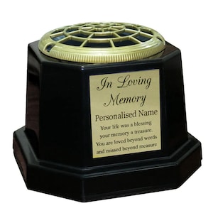 May include: Black hexagonal flower vase with a gold top and a gold plaque that reads "In Loving Memory" and "Personalised Name". The plaque also includes the text "Your life was a blessing your memory a treasure. You are loved beyond words and missed beyond measure."