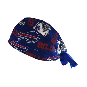 May include: Blue surgical scrub hat with a Buffalo Bills team logo and the word "Bills" repeated on the fabric.